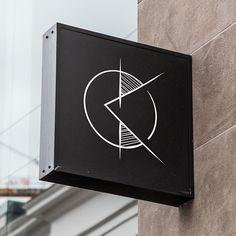 a black and white sign hanging from the side of a building