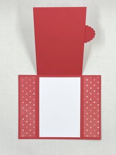 a red card with white polka dots on it and a piece of paper in the middle