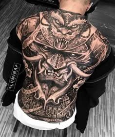 a man with tattoos on his back