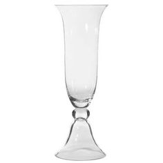 a tall glass vase sitting on top of a table