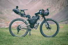 a mountain bike parked on top of a lush green field