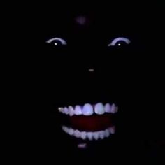 an image of a creepy face in the dark with teeth and glowing lights on it