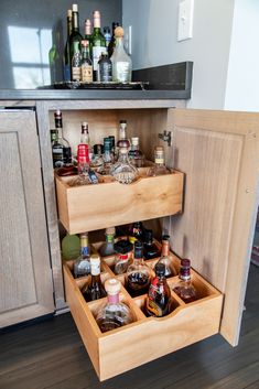 an open cabinet with liquor bottles in it