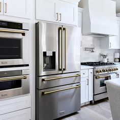 a kitchen with stainless steel appliances and white cabinets