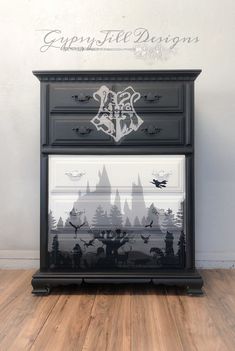 a black dresser with harry potter silhouettes on it