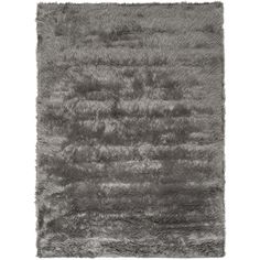 an area rug with grey fur on the bottom, and gray carpet in the middle