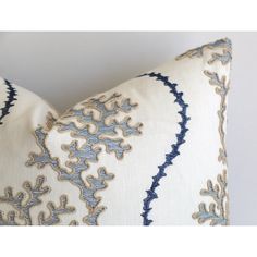 a blue and white pillow with an intricate design on it