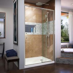 a bathroom with a walk in shower next to a bath tub