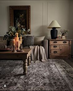 a living room filled with furniture and a rug on top of a wooden coffee table