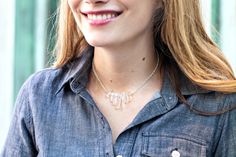 a close up of a person wearing a blue shirt and smiling at the camera with long blonde hair