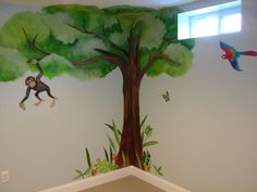 this is a child's room painted with monkeys and trees