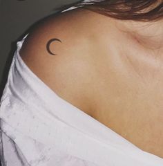 a woman with a crescent tattoo on her shoulder