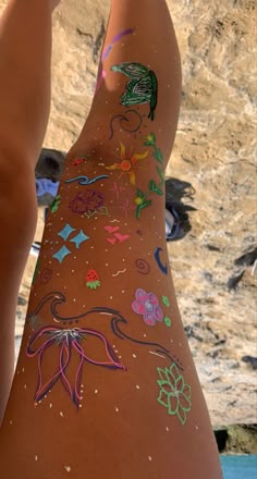 a woman's legs covered in various colored drawings on the side of her body