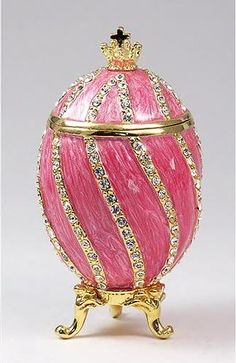 a pink and gold decorated egg with diamond trim