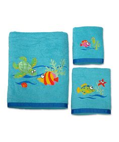 three towels with fish and sea animals on them