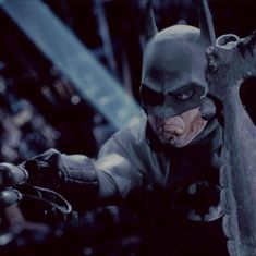 the dark knight rises batman action figure is shown in this still - life scene from the film