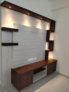 an entertainment center with shelves and lights on the wall