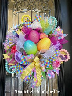 an easter wreath is hanging on the front door