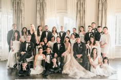 a large group of people in formal wear posing for a photo