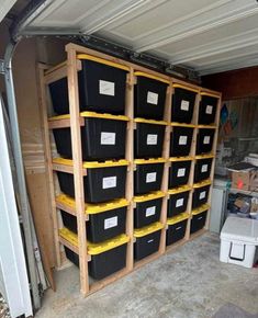 the storage room is filled with black and yellow bins in order to keep things organized