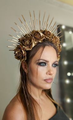 a woman wearing a gold crown with flowers on her head