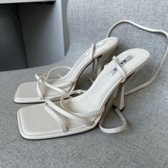 White Heels With Straps That Twist Around The Ankles. No Defects, Never Worn. Na-kd Shoes, Cream Heels With Wrapped Heel And Square Toe, Cream Strappy Heels For Party, Cream Strappy Heels For Evening, Cream Strappy Heels With Padded Heel, Cream Strappy Heels With Wrapped Heel, Cream Strappy Synthetic Heels, Cream Synthetic Strappy Heels, White Lace Heels