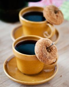 three coffee cups with donuts on them