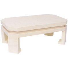 a white coffee table sitting on top of a wooden floor