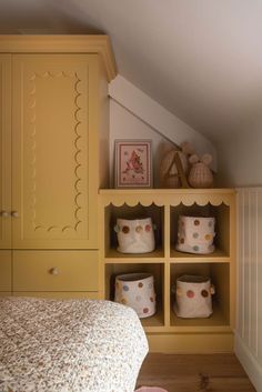 a bedroom with yellow cabinets and white bedspread