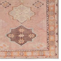 an antique rug with two different colors and designs on the front, one is pink