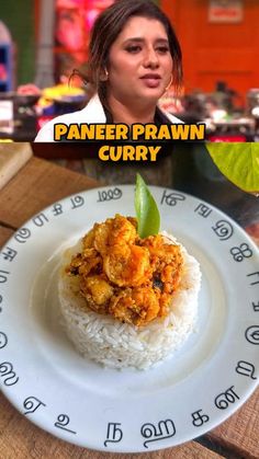 a woman sitting at a table in front of a plate with rice and chicken curry on it