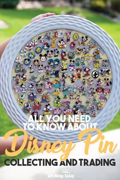 someone holding up a disney pin with mickey mouses on it and the words, all you need to know about disney pin collecting and trading