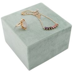 three different types of jewelry sitting on top of a box