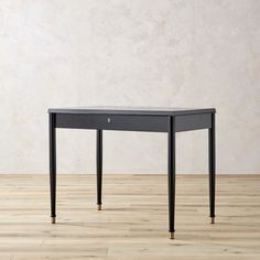 a small black table on top of a hard wood floor