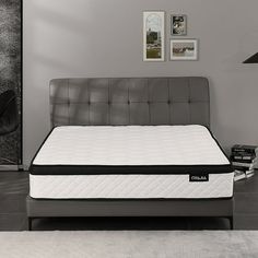 a bed with a mattress on top of it in a room