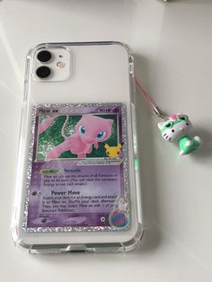 an iphone case with a charm attached to it