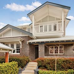 the house is made of brick and has two balconies