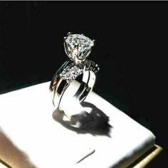 a diamond ring sitting on top of a white box