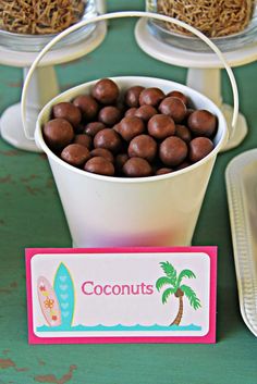 there is a bowl of chocolates on the table with other dessert items around it