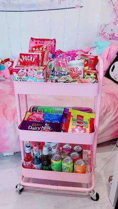 a pink cart filled with candy and snacks