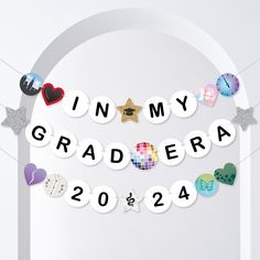 an arch decorated with magnets and paper cutouts that spell out the word graduation