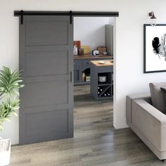 a living room filled with furniture and a sliding door