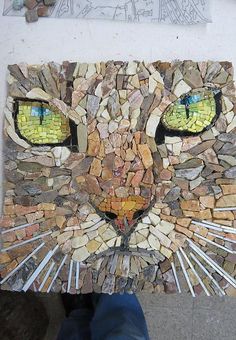 a close up of a cat made out of rocks