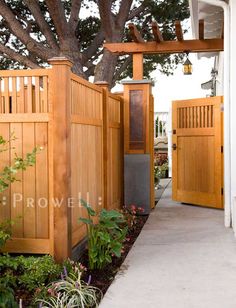 an entrance to a home with wooden gates