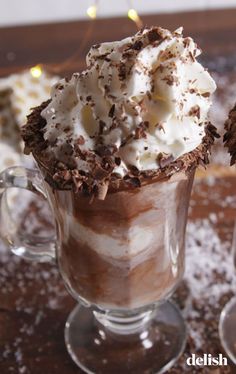 two glasses filled with hot chocolate and whipped cream