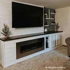 a flat screen tv mounted to the side of a wall above a fireplace in a living room