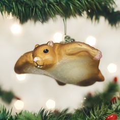 a hamster ornament hanging from a christmas tree