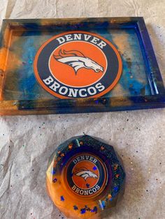 an orange and blue denver sign sitting next to a bottle opener