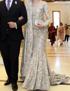 a man and woman in formal wear standing next to each other on a marble floor