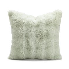 a white pillow that is made out of sheepskin and has a long pile of fur on